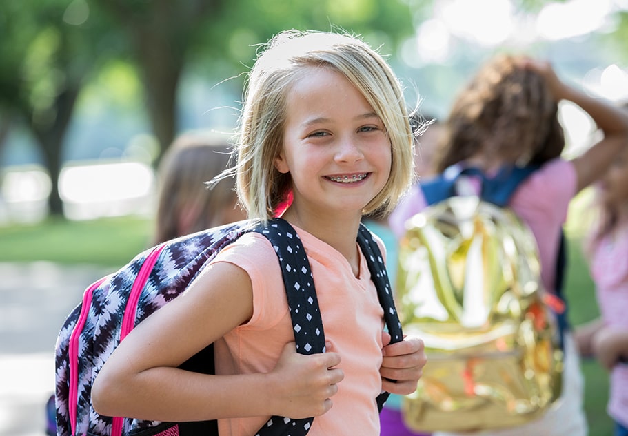 Destin Education girl smiling with backpack going to destin school