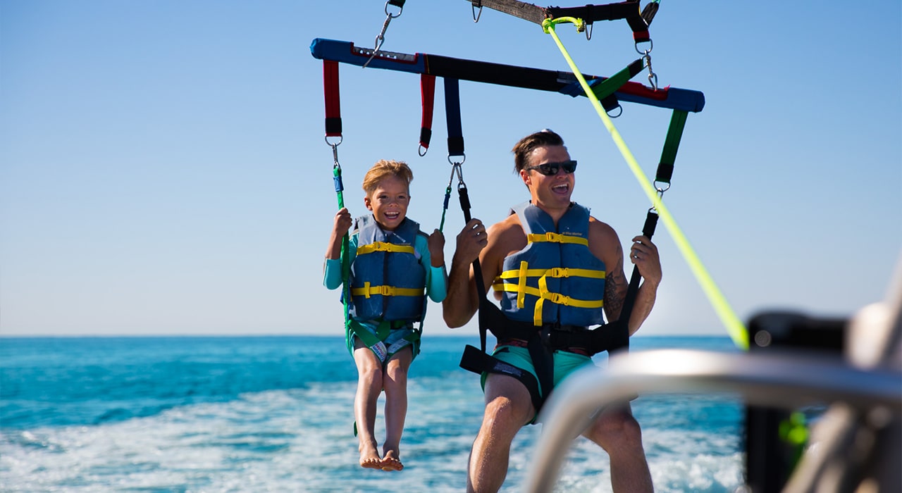 Outdoor Exploration – Watersports father and son parasailing in destin florida